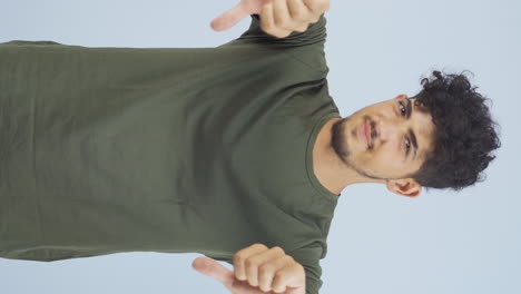 Vertical-video-of-Man-looking-at-camera-with-a-negative-expression.